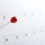 A red pin on calendar to remind about the appointment, Tax Day 2018 takes place on April 17, 2018